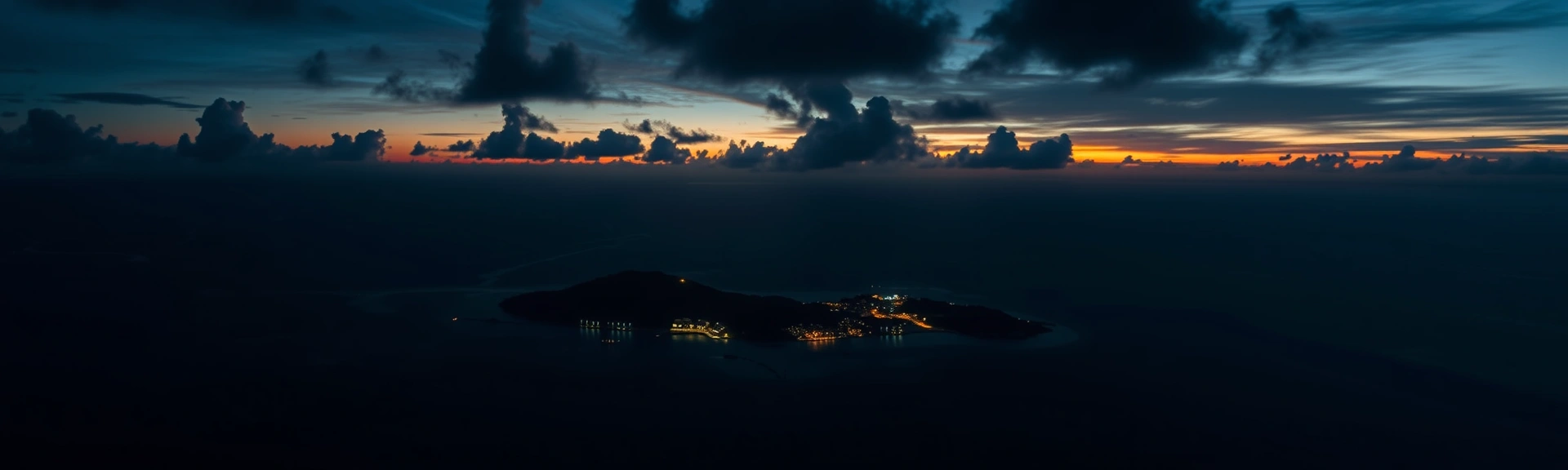 Aerial twilight view of a Caribbean island with resort lights